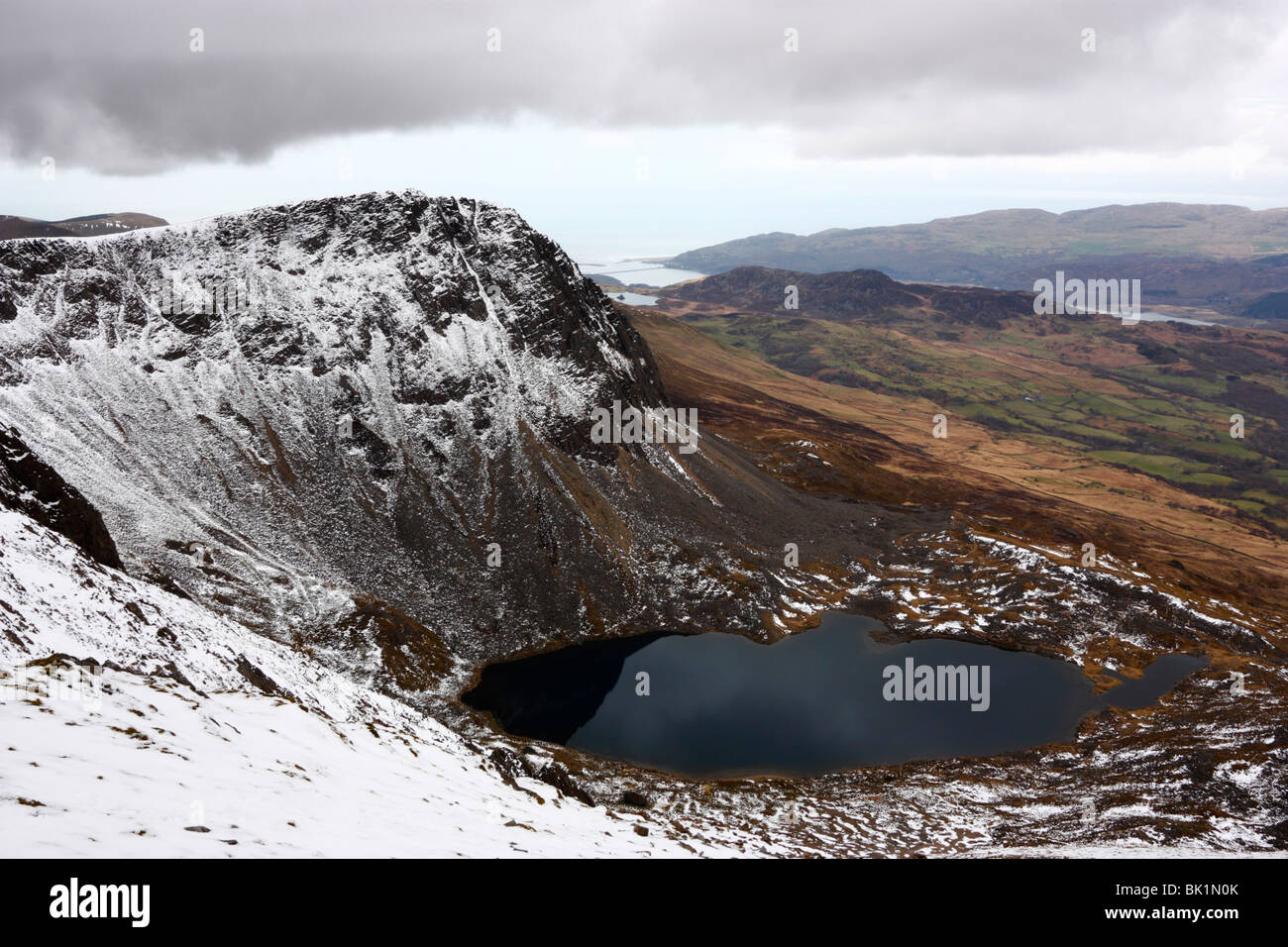 The peak of Cyfrwy and the Cyfrwy Arete rise above Llyn y Gadair on Cadair Idris, Snowdonia Stock Photo
