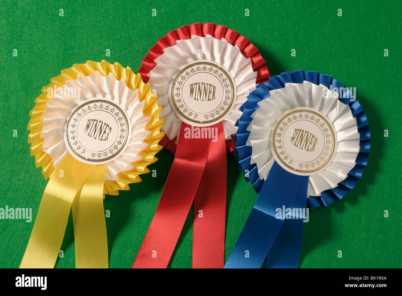 Blue,Yellow and Red winners Rosettes. Stock Photo