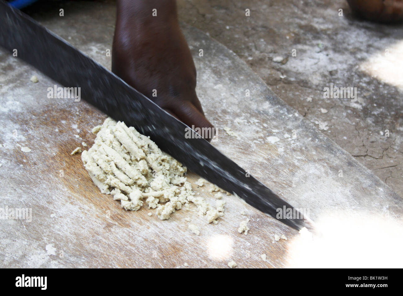Dorze village. Woman prepares bread from the shaving a leaf of the fruitless Banana. Stock Photo