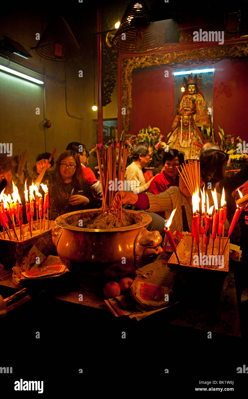 Man-Mo Temple Hong Kong, lighting incense candles for good luck. Stock Photo