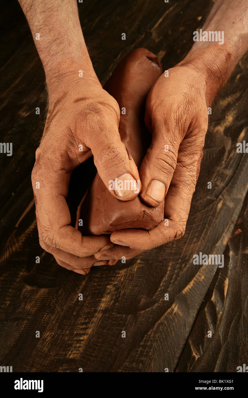 pottery craftsmanship potter craftsman hands working red clay Stock Photo