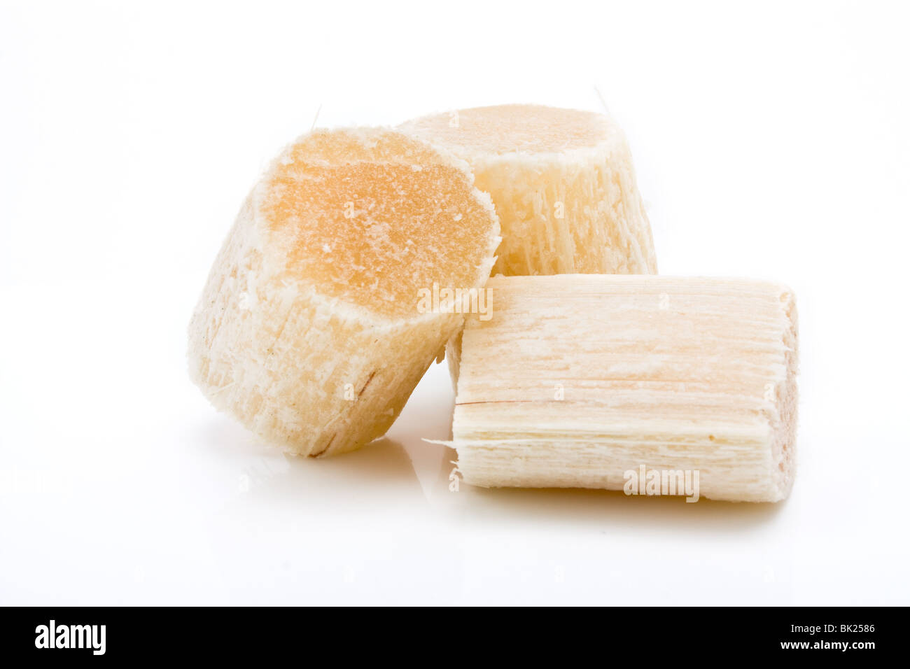 Chunks of Raw Sugar Cane against white background. Stock Photo