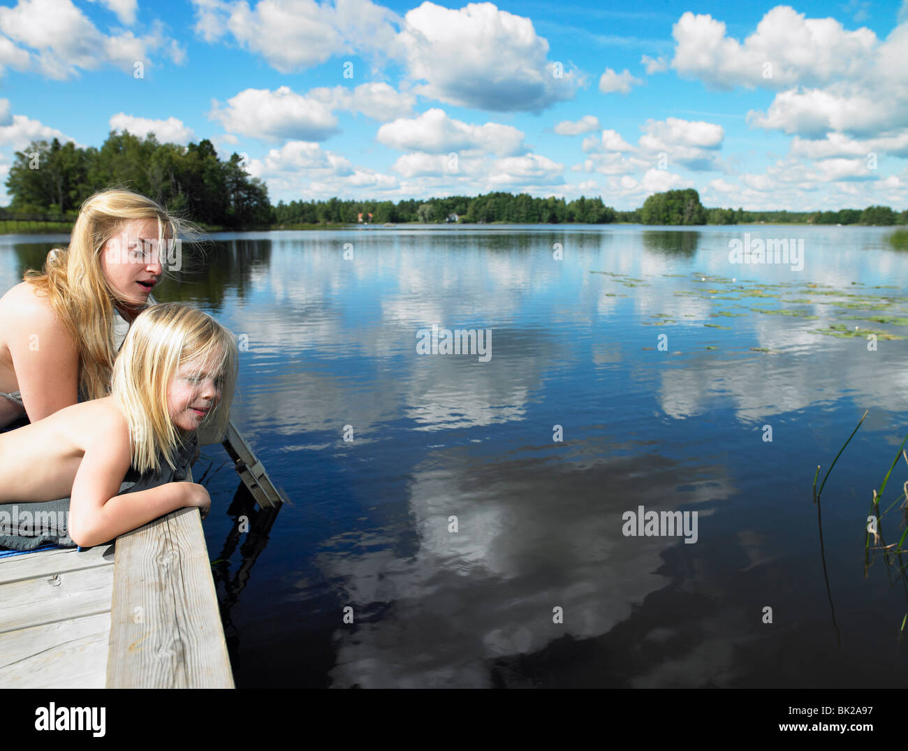 Woman and girl on a dock Stock Photo
