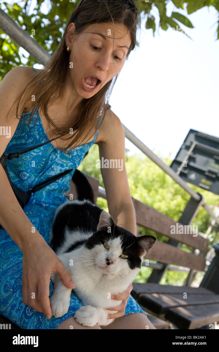 Girl with cat digging its claws into her legs Stock Photo Alamy
