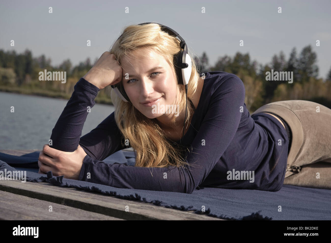 Young woman lying on blanket,smiling Stock Photo Alamy