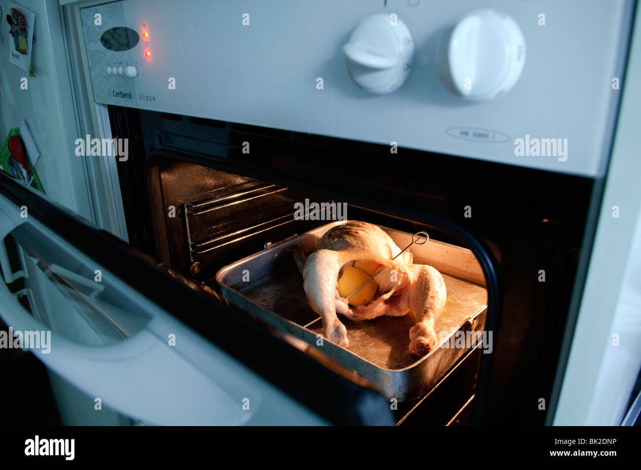 whole chicken roasting in Oven Stock Photo Alamy