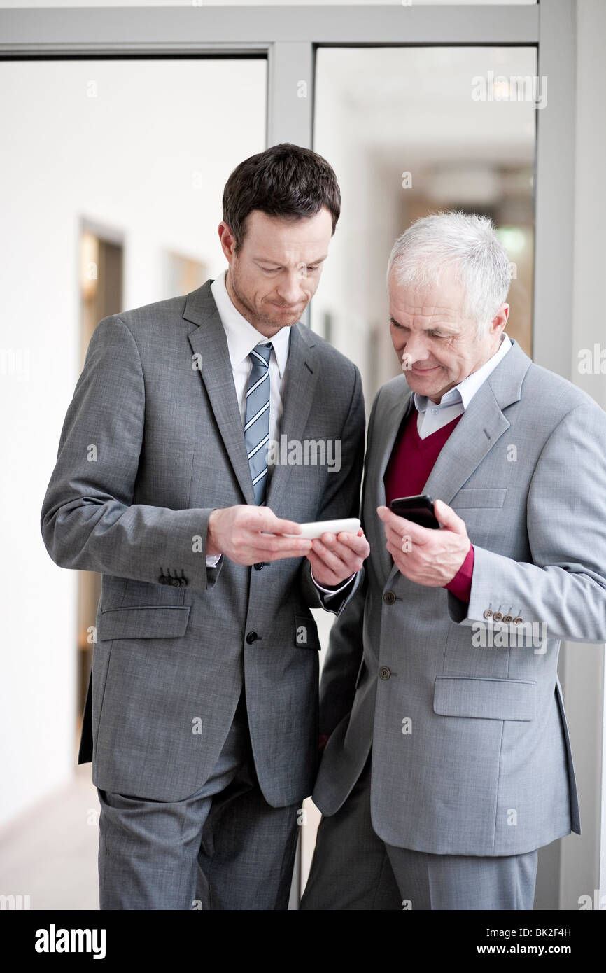 2 businessmen with handhelds Stock Photo