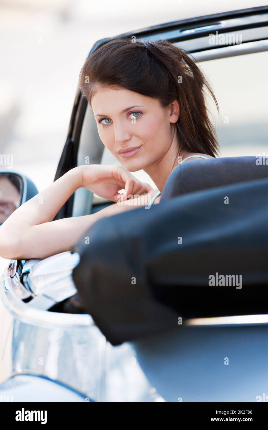 Woman leaning out of car window Stock Photo