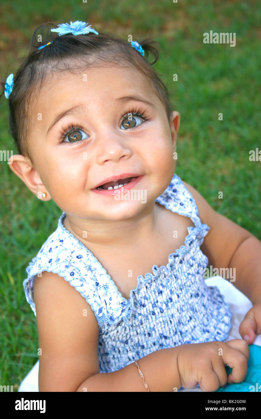 Little brunette smiling girl with bracelet Stock Photo - Alamy