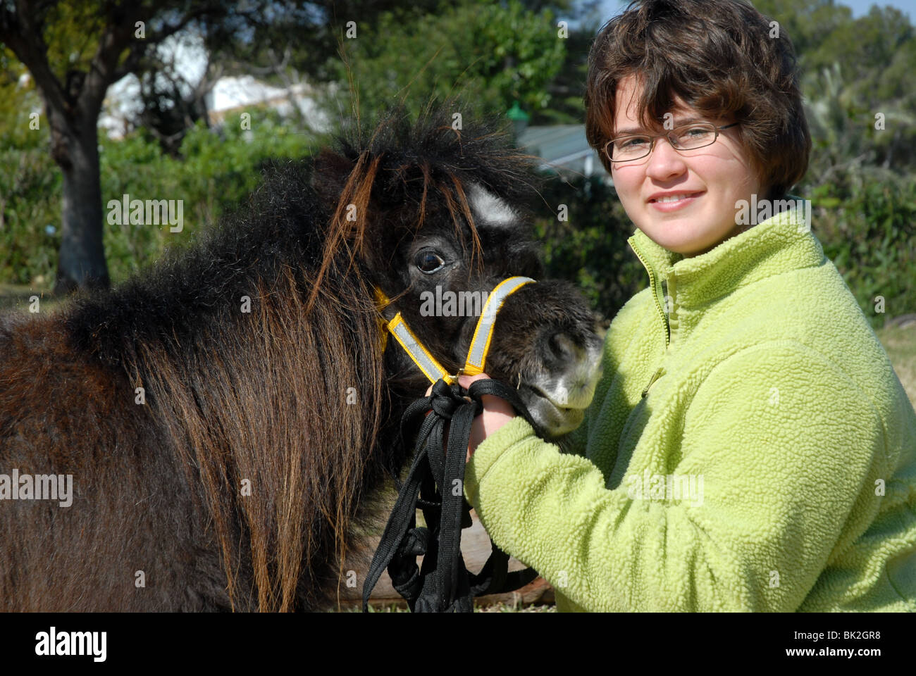 young girl (aged 11), with pet Falabella Miniature horse Stock Photo