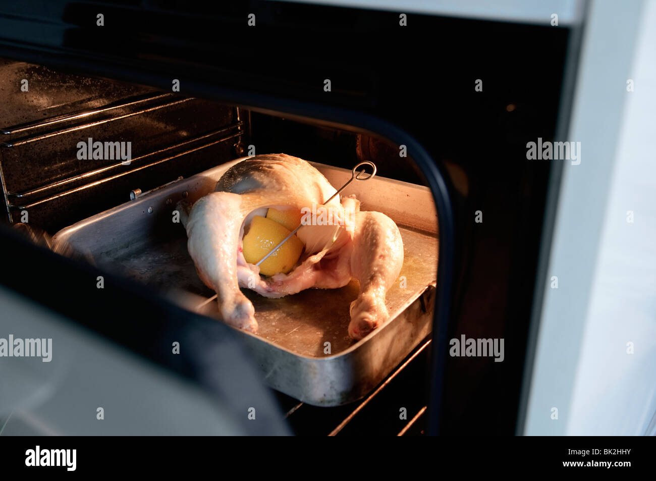 whole chicken roasting in Oven Stock Photo Alamy