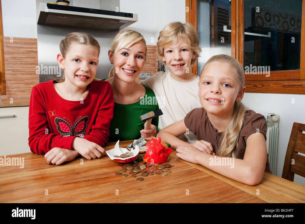 Family smash open a piggy bank Stock Photo - Alamy