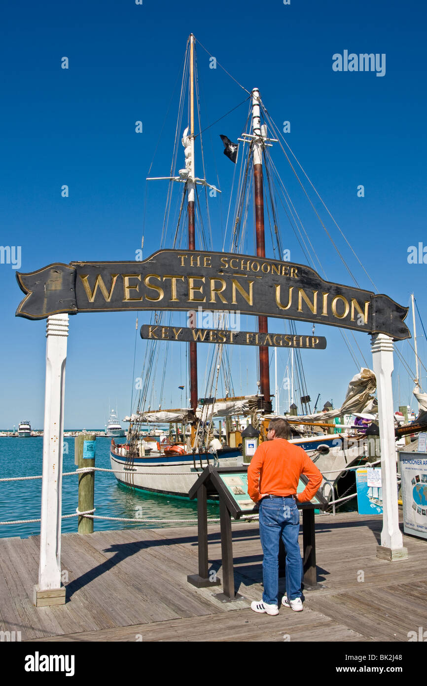 The Schooner Western Union sign and tall ship at the marina, Florida, USA.  Tourist reading information board Stock Photo - Alamy