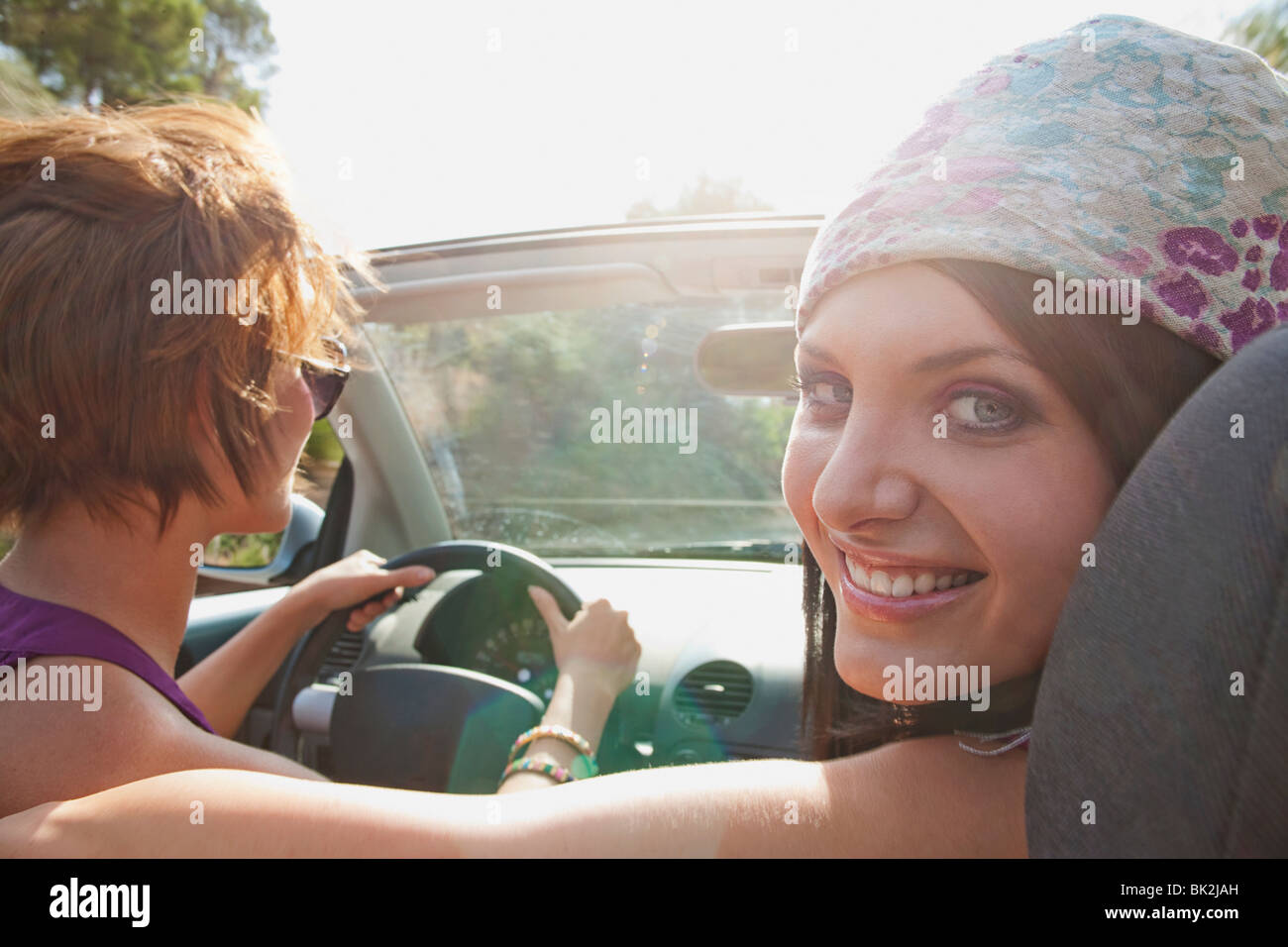 Two women in convertible car in the sun Stock Photo