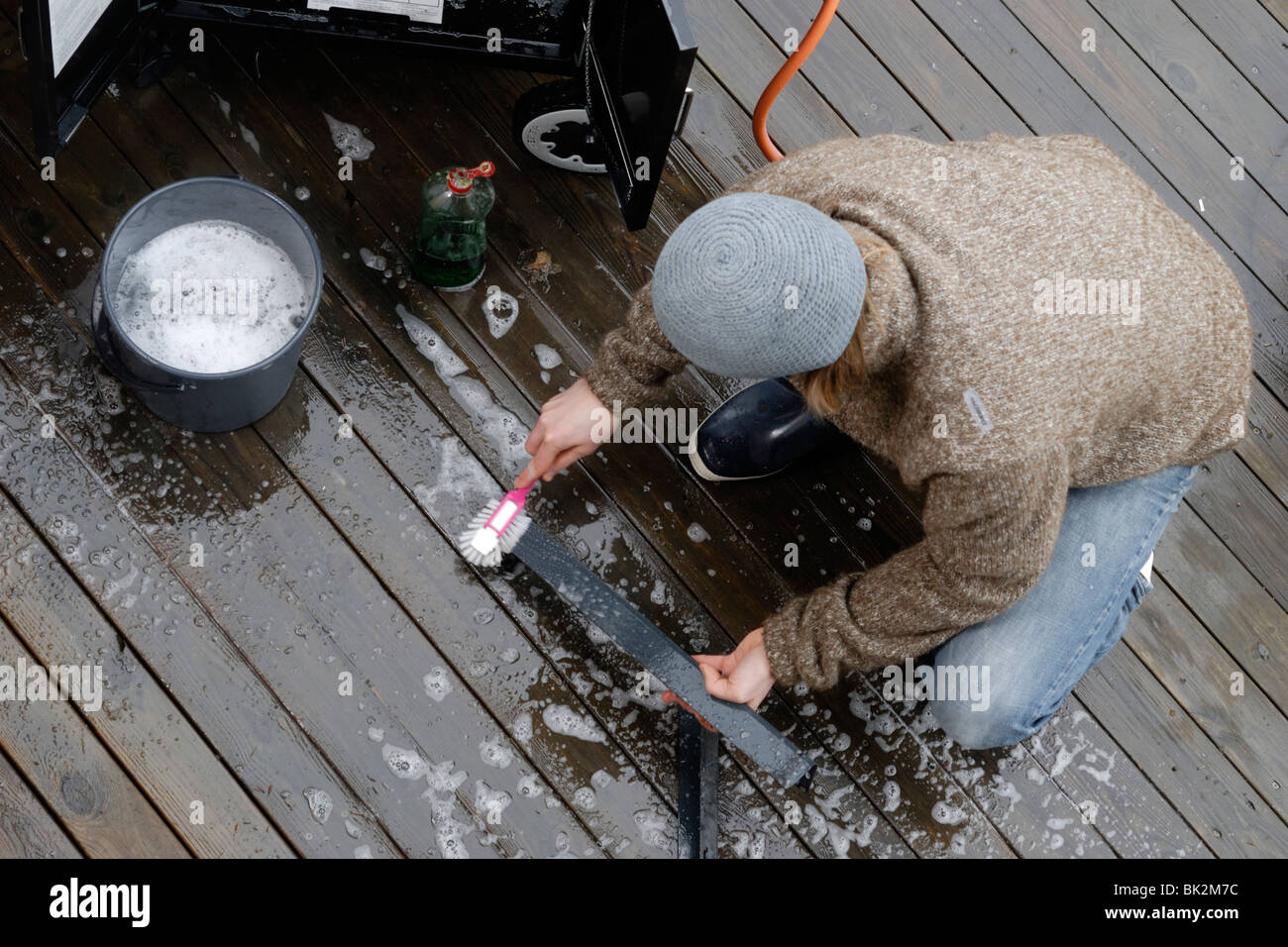 Man cleaning grill in spring Stock Photo Alamy