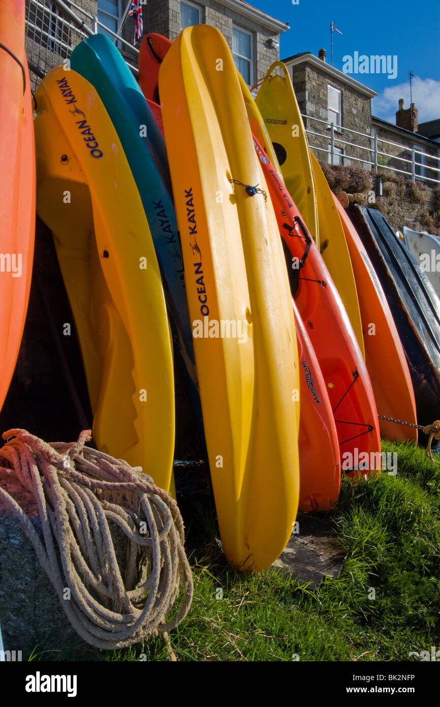Colourful canoes at Mousehole harbour, Cornwall, uk Stock Photo Alamy