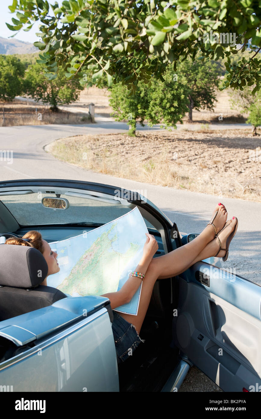 A woman reading a map in a car Stock Photo