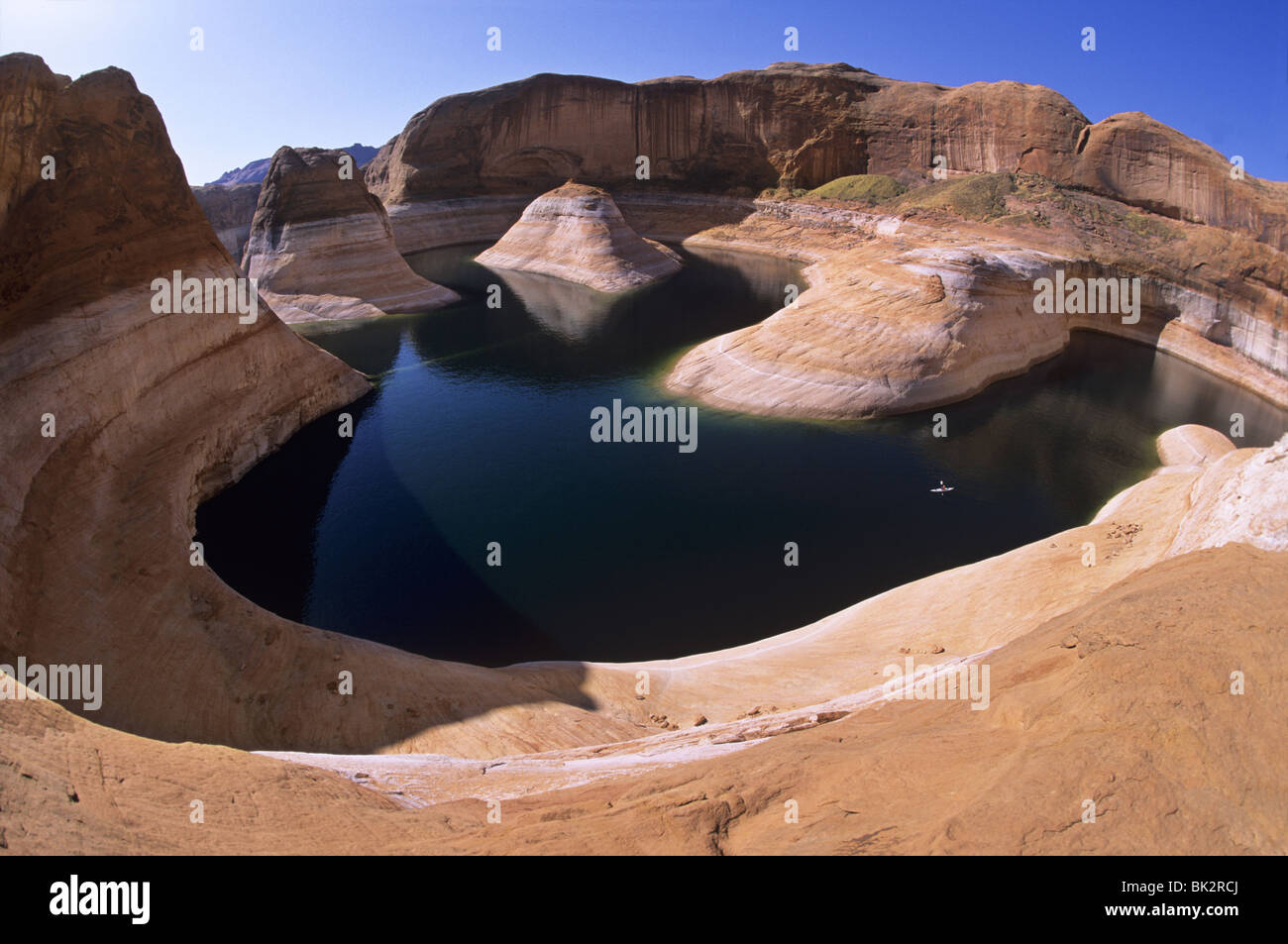 Kayaking (center right) on Lake Powell in Reflection Canyon beneath the