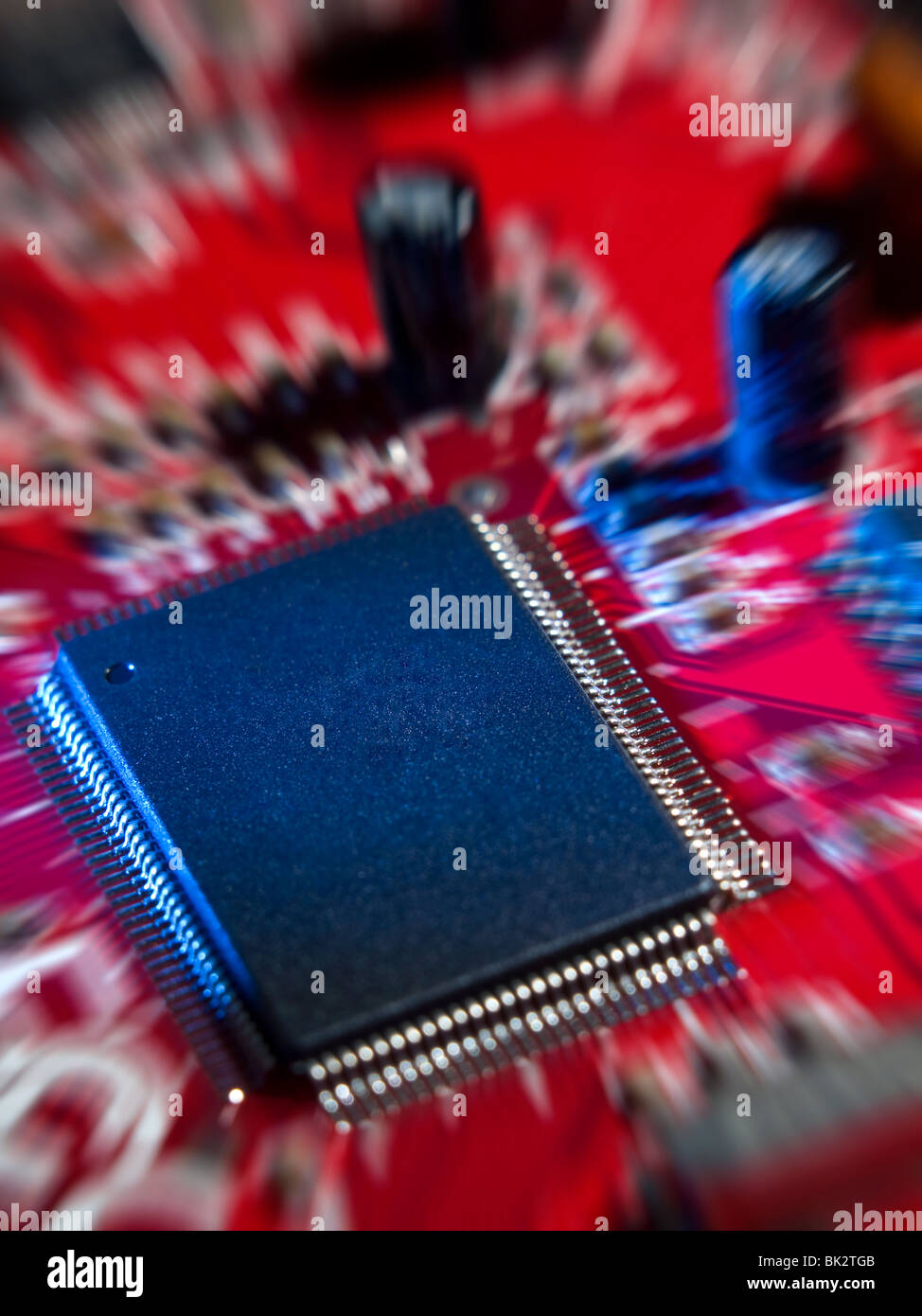 Zoom in on red computer circuit board with memory chip. Stock Photo