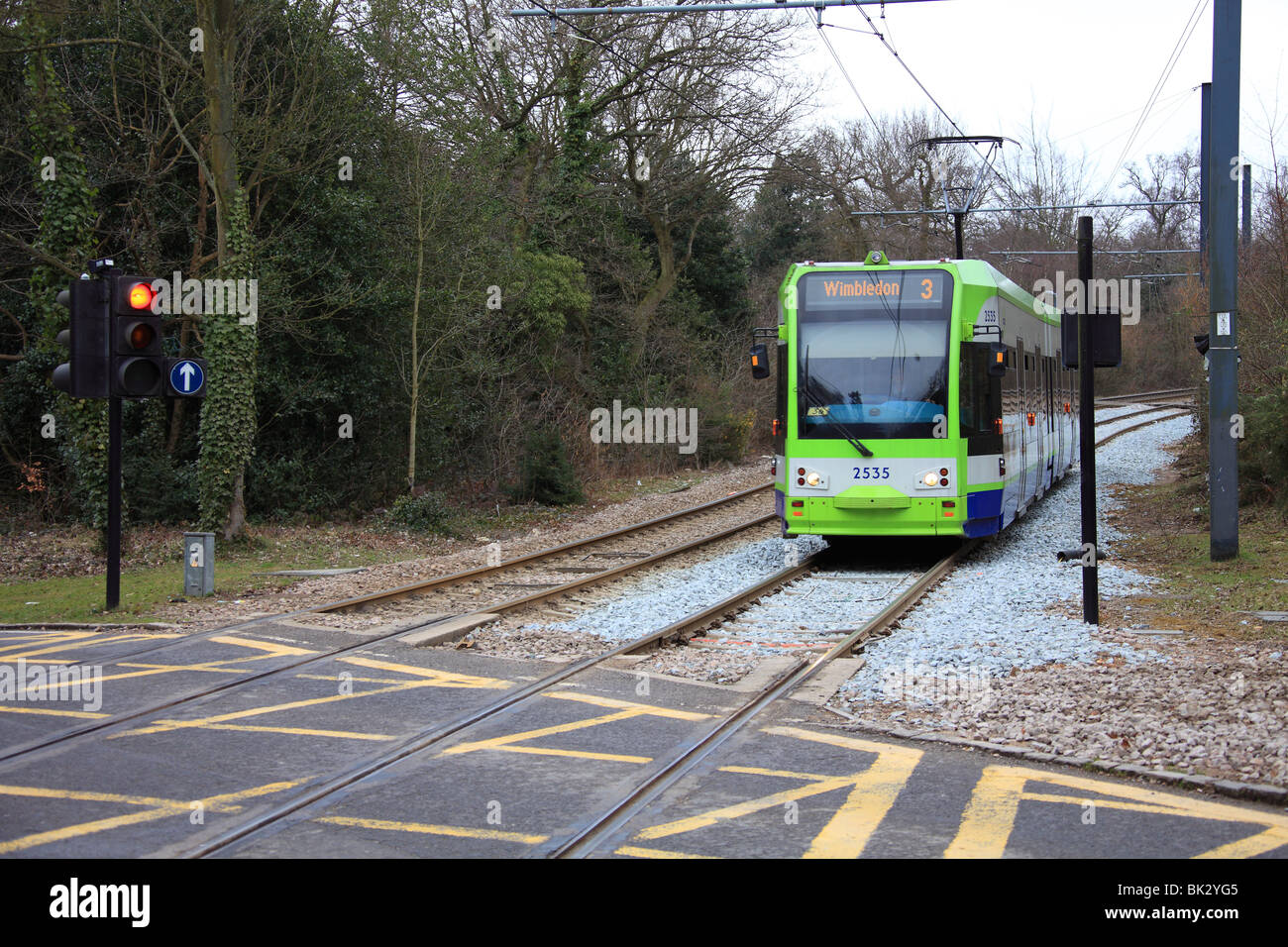 Passenger carrying trams of the Croydon Tramlink at a level crossing in ...