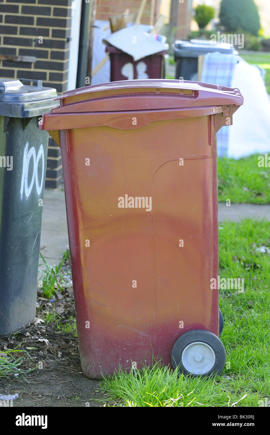 Domestic rubbish 'wheelie bins' waiting outside houses for refuse collection, Reading, Berkshire, United Kingdom Stock Photo
