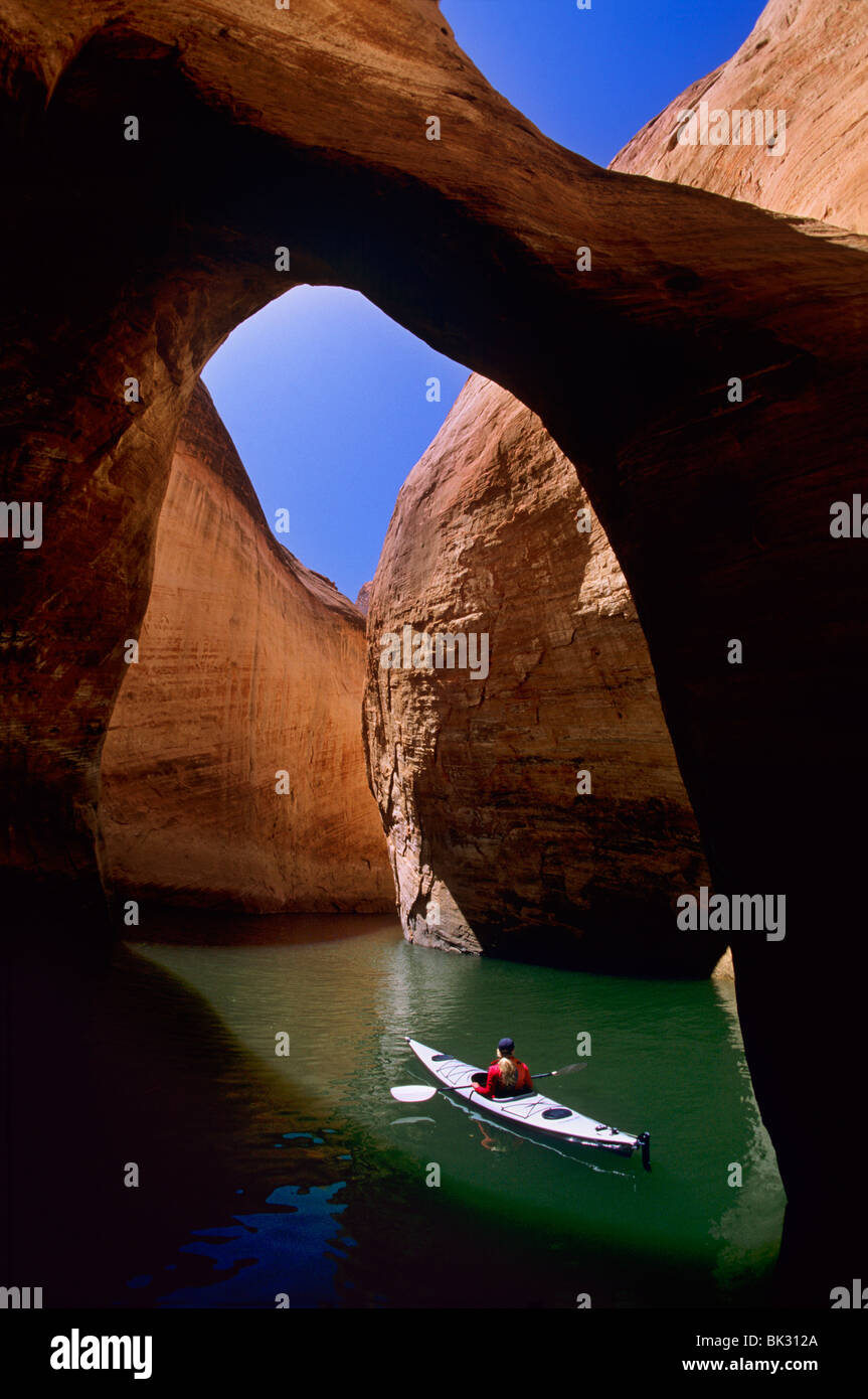 Kayaking on Lake Powell beneath a natural bridge in Anasazi Canyon