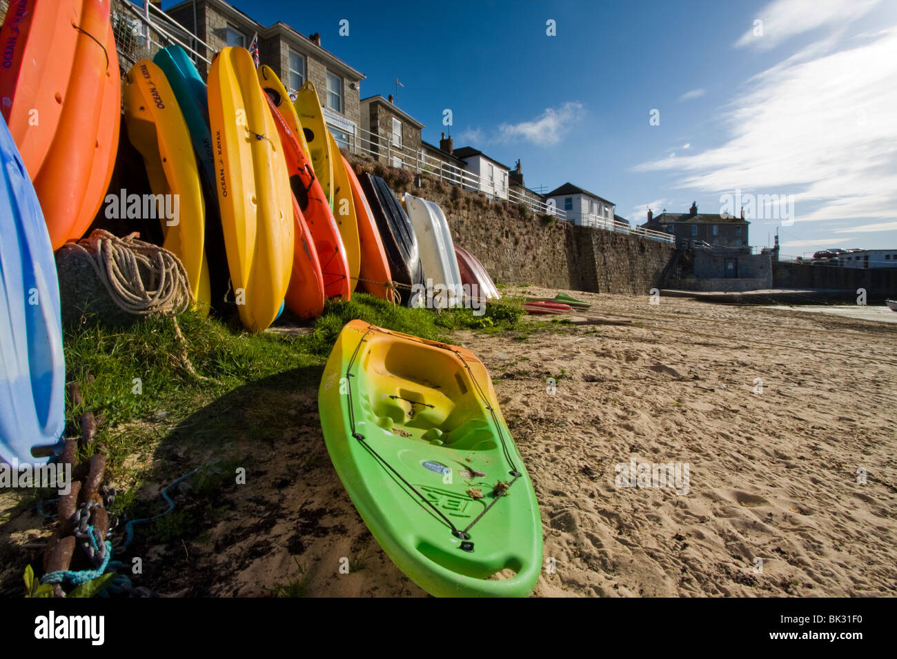 Canoes on the beach in Mousehole harbour, Cornwall, uk Stock Photo Alamy