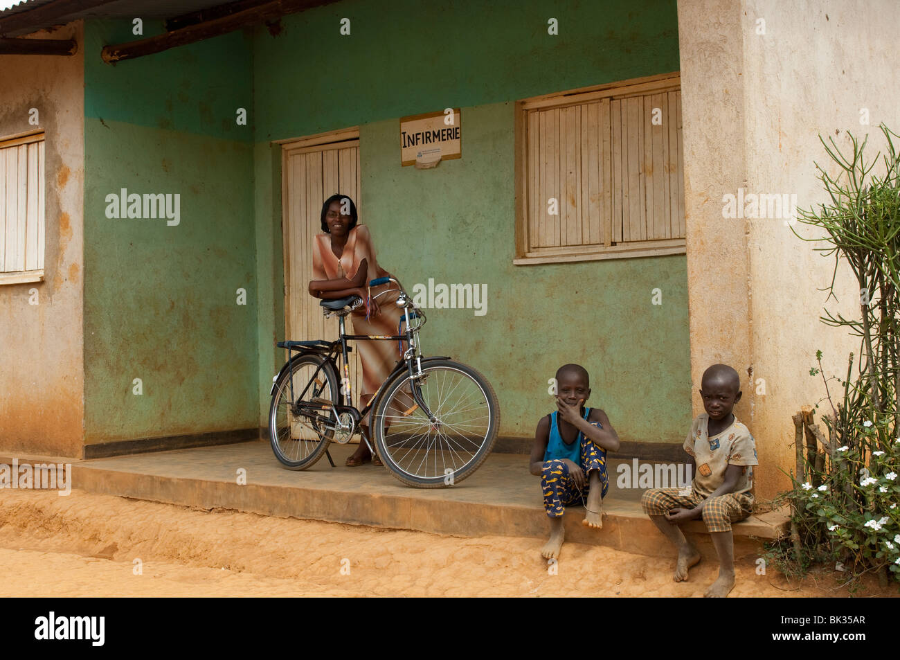 Local nurse outside her surgery with a Bicycle. Rwanda. Stock Photo