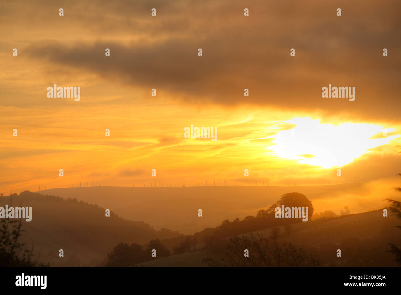 Dawn over Hafren valley and the Llandinam Windfarm, near Llanidloes, Powys, Wales. Stock Photo