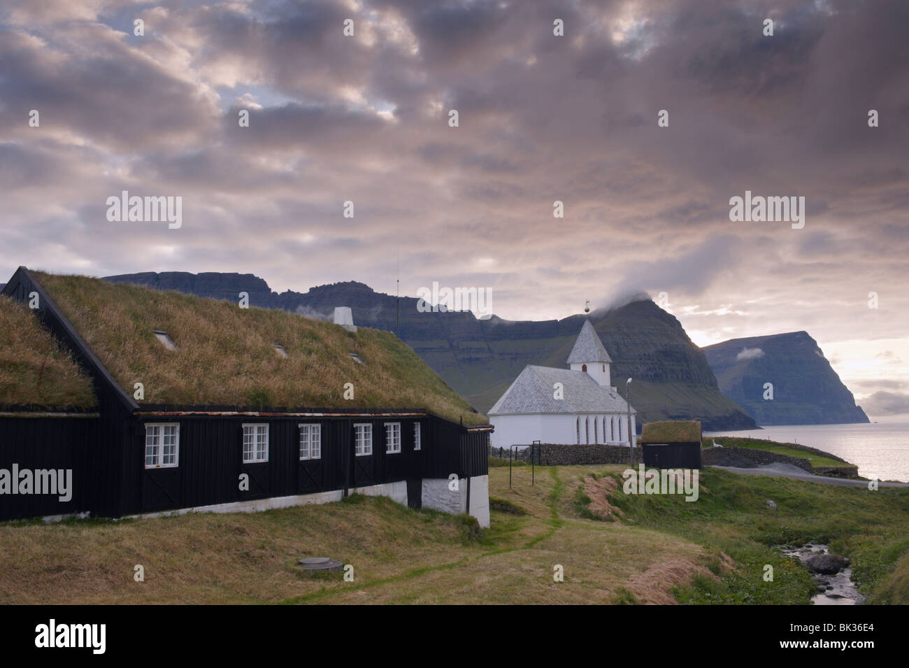 Vidareidi church dating from 1892, and turf-roofed vicarage, Vidoy Island, Nordoyar, Faroe Islands (Faroes), Denmark, Europe Stock Photo