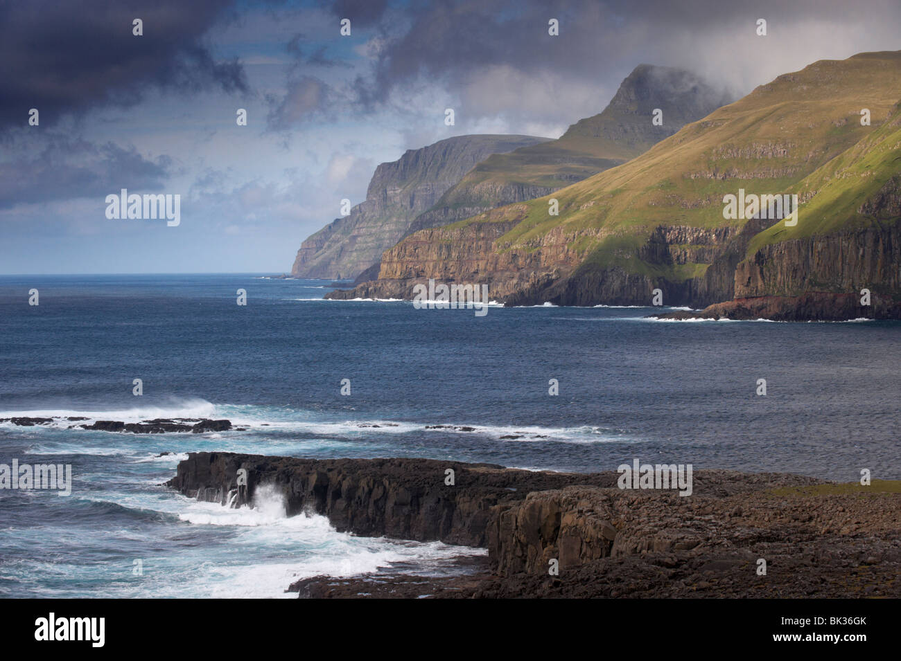 Sea cliffs and surf near Famjin (Logvatangi, Brimnestangi), on Suduroy west coast, Suduroy Island, Faroe Islands Stock Photo