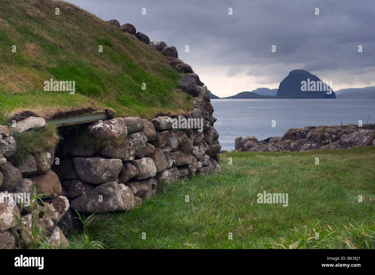 Old fisherman hut and Koltur island, from Kirkjubour, Streymoy, Faroe Islands (Faroes), Denmark, Europe, Europe Stock Photo