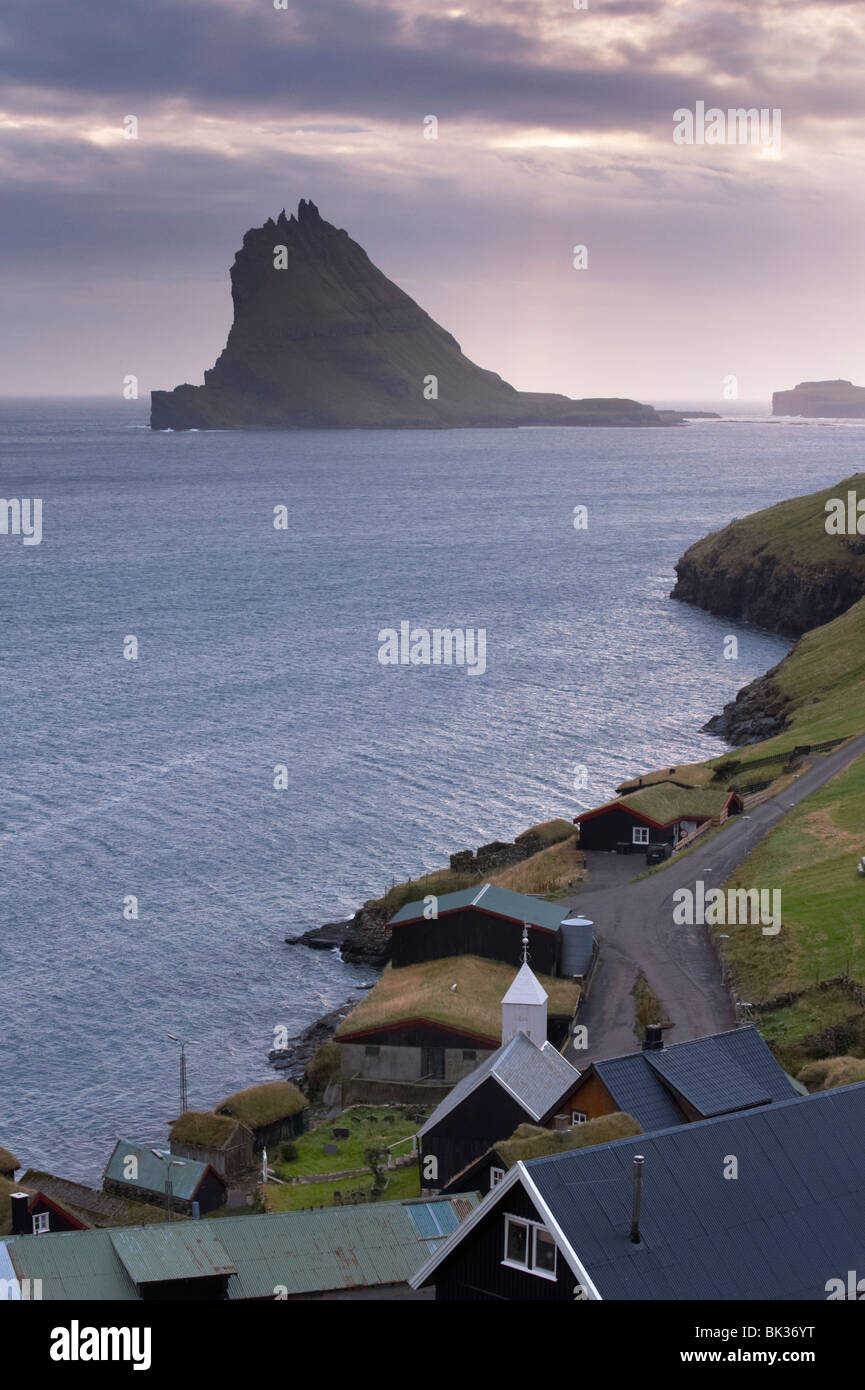 Village of Bour and Tindholmur island rising to 262m, at sunset from Vagar, Faroe Islands (Faroes), Denmark, Europe Stock Photo