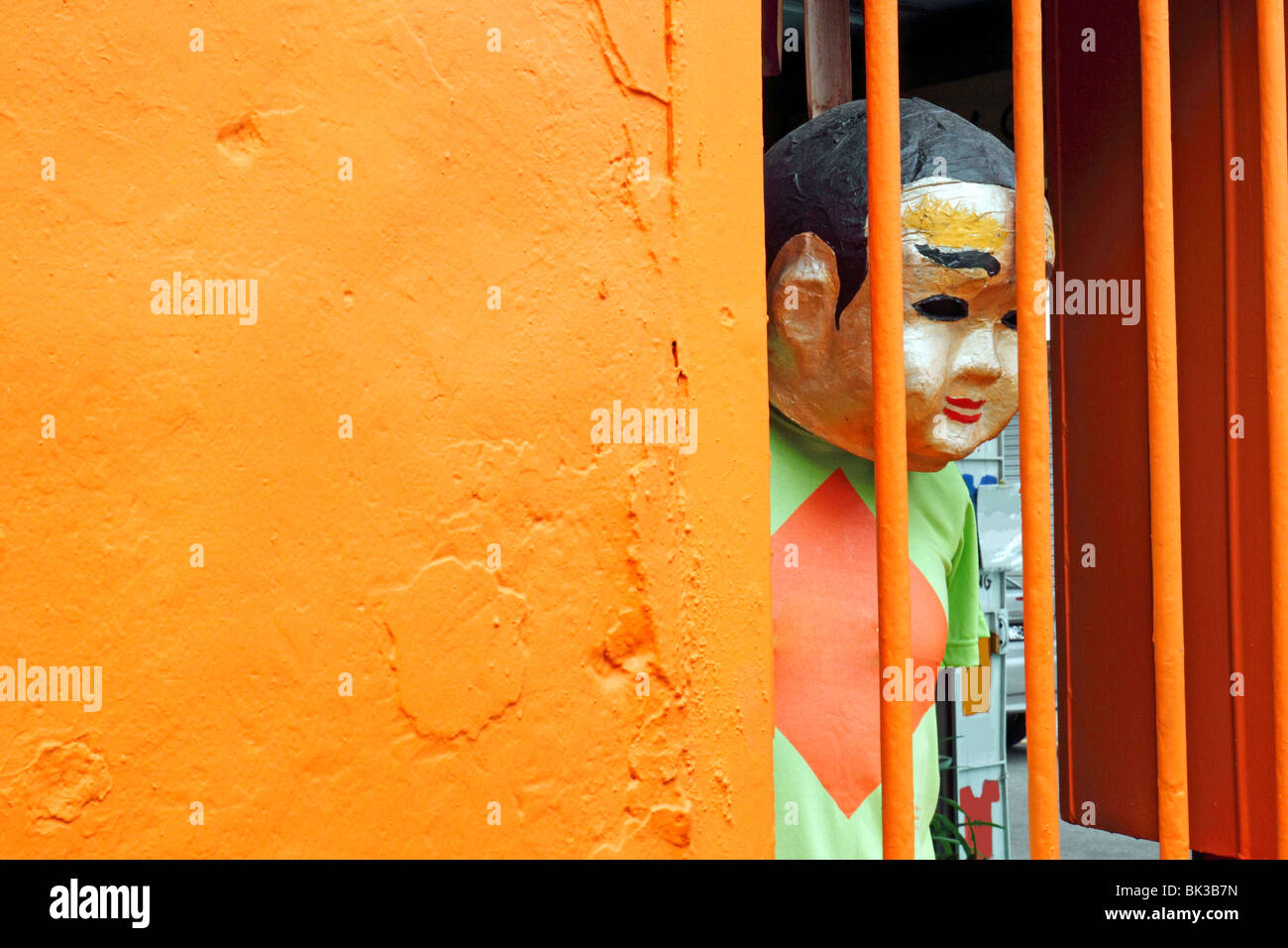 A dummy appears to look out of its jail window as if feeling despair & lonely. Stock Photo