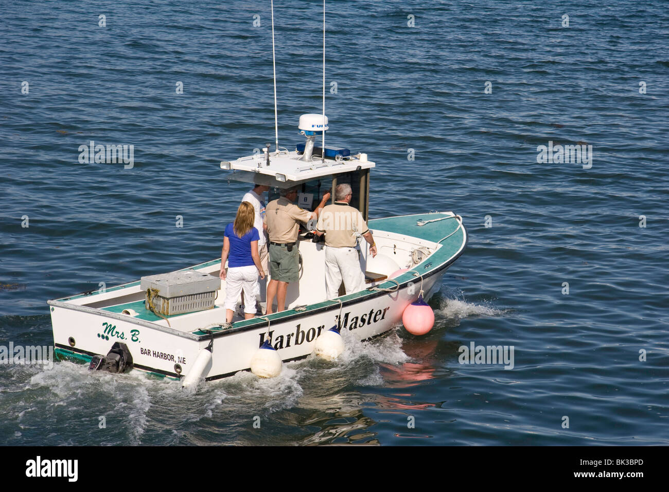 The Harbor Master takes a spin in his boat at Bar Harbor, Maine Stock