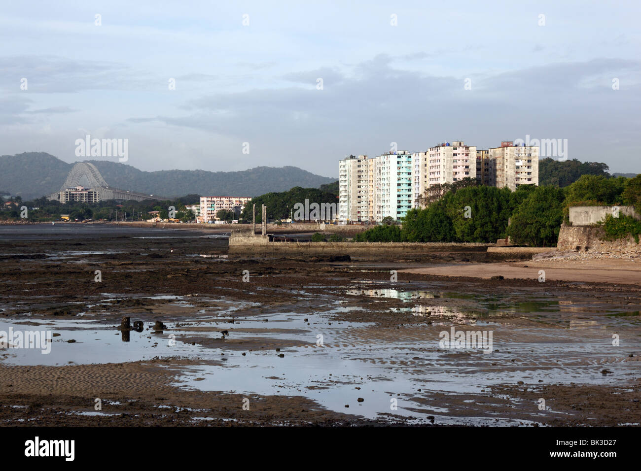 View of tower blocks in El Chorrillo at low tide from Casco Viejo, Bridge of Americas in background , Panama City , Panama Stock Photo