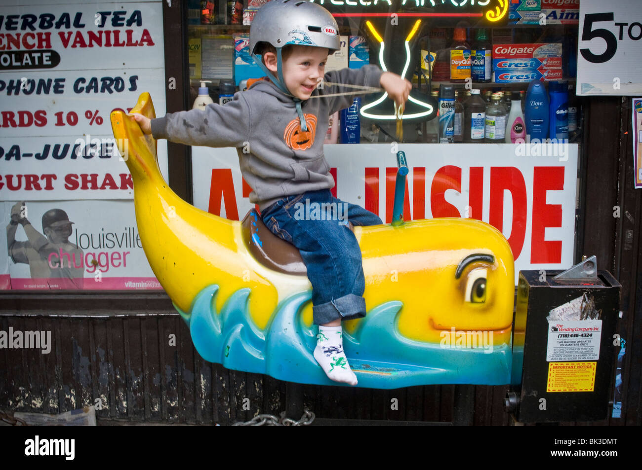 One young boy riding store front children's ride Stock Photo Alamy