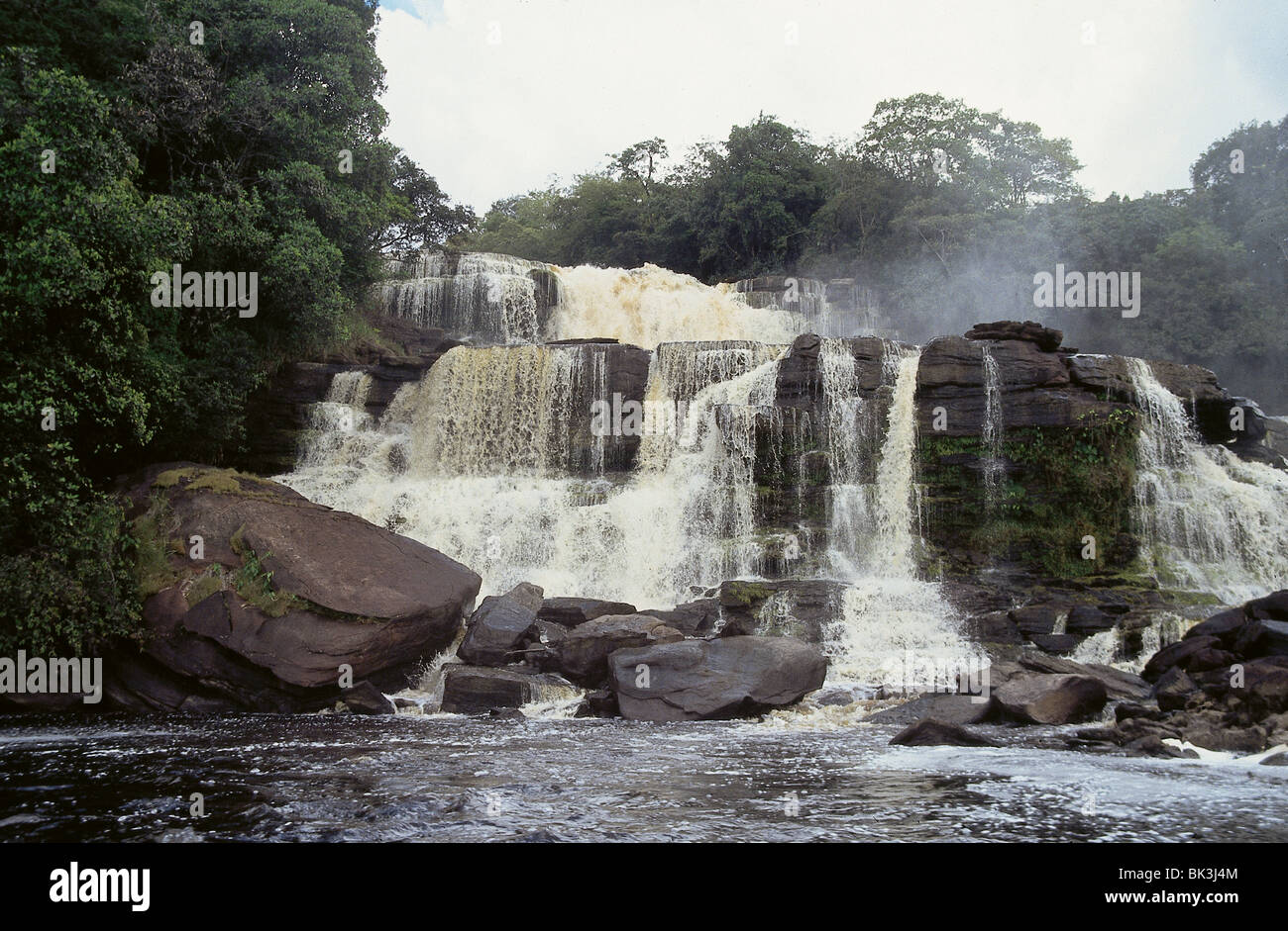 The Carrao River cascades over Hacha Falls with brown tint of water coming from tannins leached from surrounding forests Stock Photo