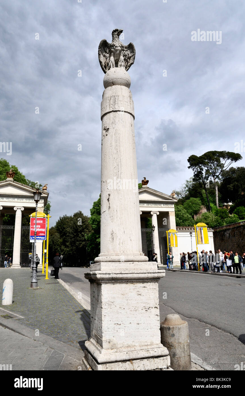 A statue of the Borghese Eagle stands on a column outside the Ionian Propyla built as a new entrance to the Villa , Rome Stock Photo