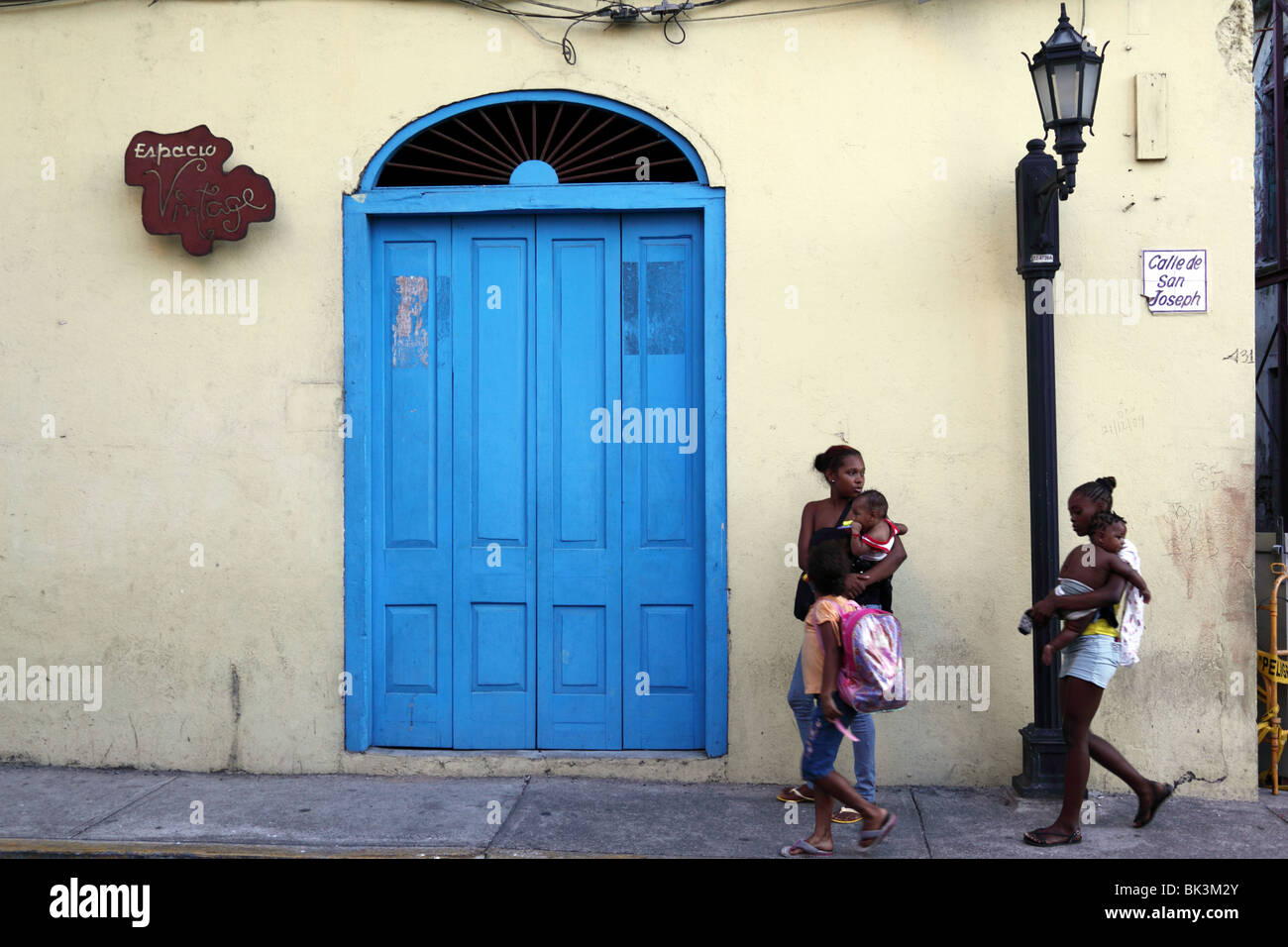 Women passing colonial doorway , Casco Viejo , Panama City , Panama Stock Photo