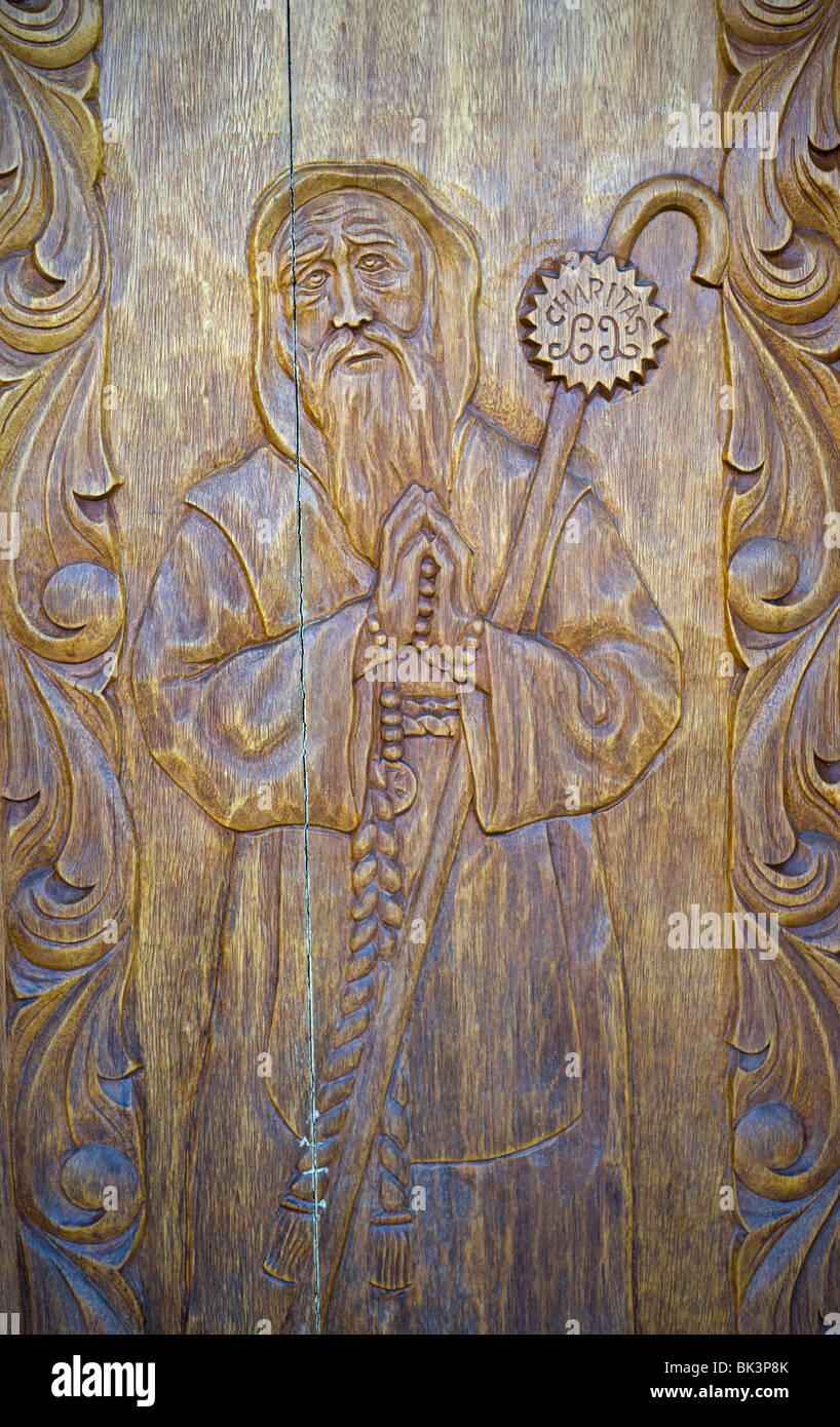 A hand-carved wood door at the entrance to Saint Francis de Paula Franciscan Mission, founded in 1865, in Tularosa, New Mexico. Stock Photo