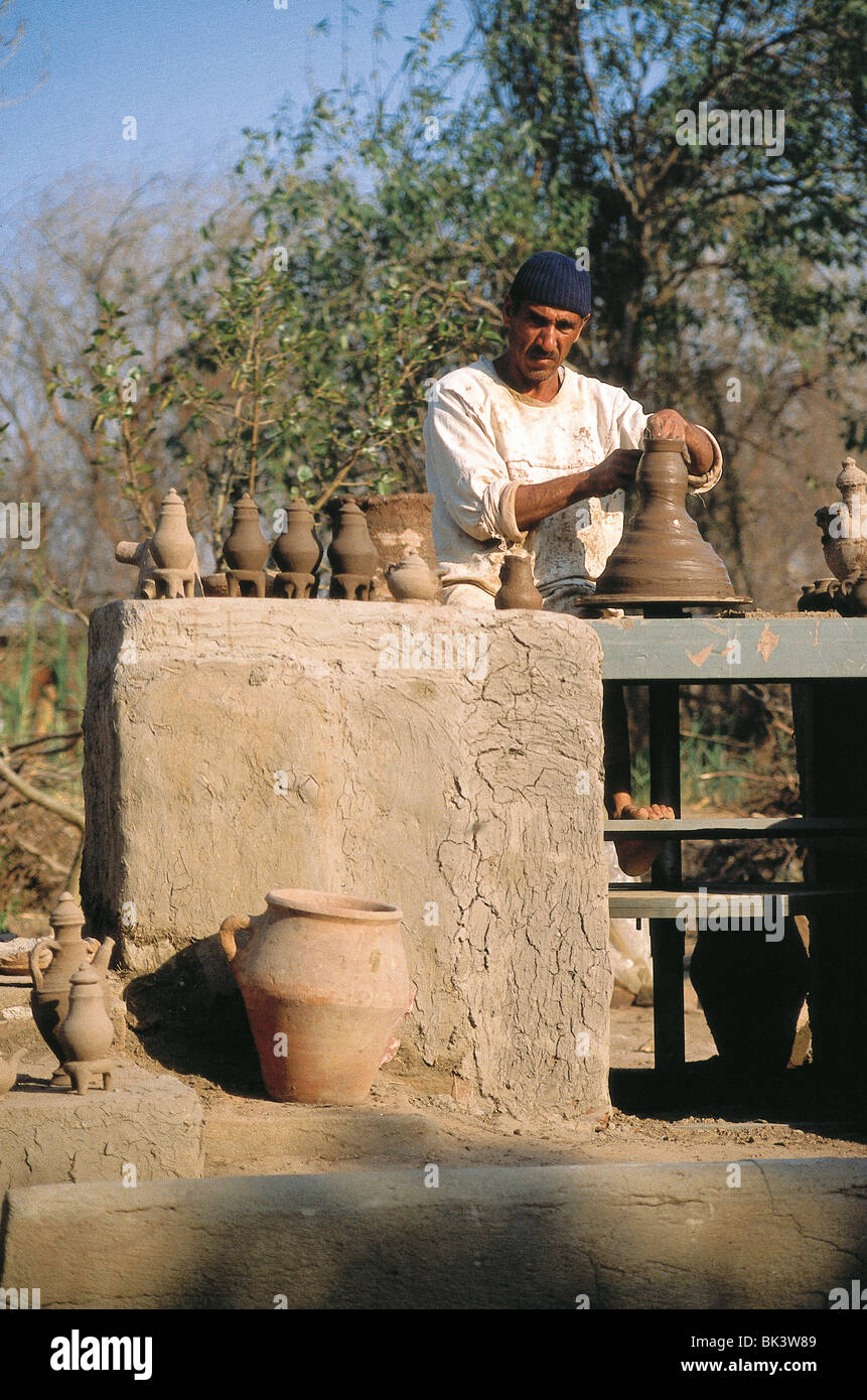 Egyptian man making clay ceramics at a pottery wheel in Egypt Stock