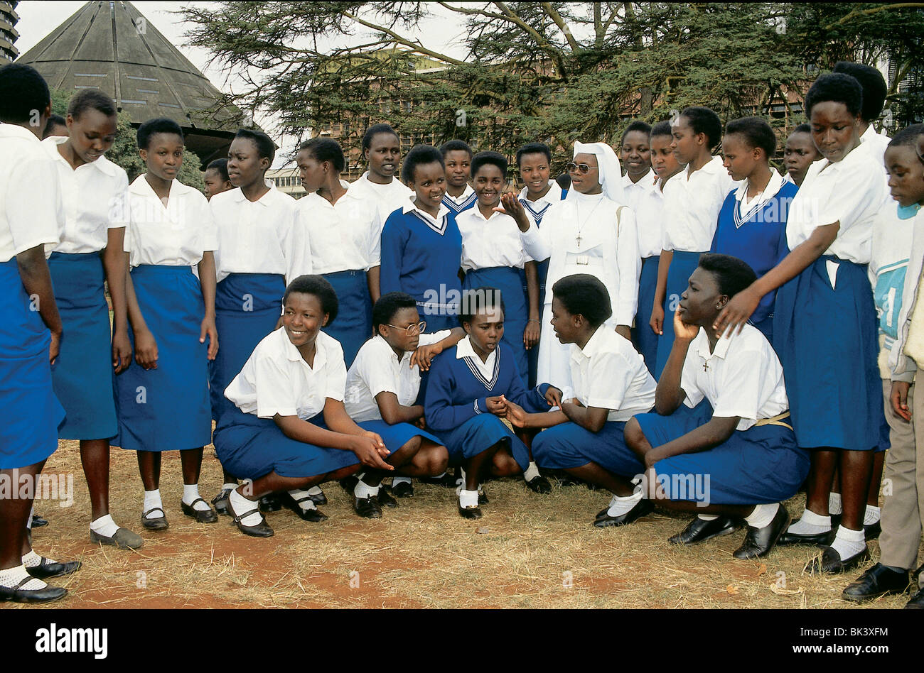Students in uniforms with a Roman Catholic nun, Nairobi, Kenya Stock Photo