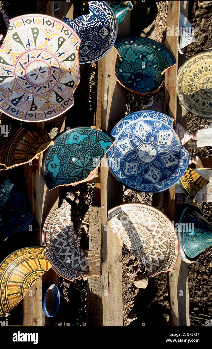 Broken piece of colorful earthenware pottery decorated with elaborate designs for sale as tourist souvenirs in Ouarzazate, Morocco Stock Photo