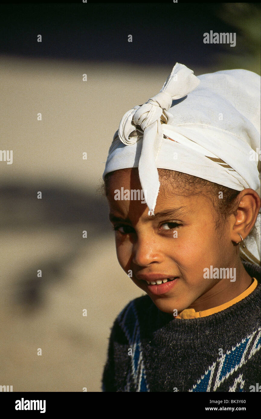 Portrait of a young girl wearing traditional clothing and headscarf in