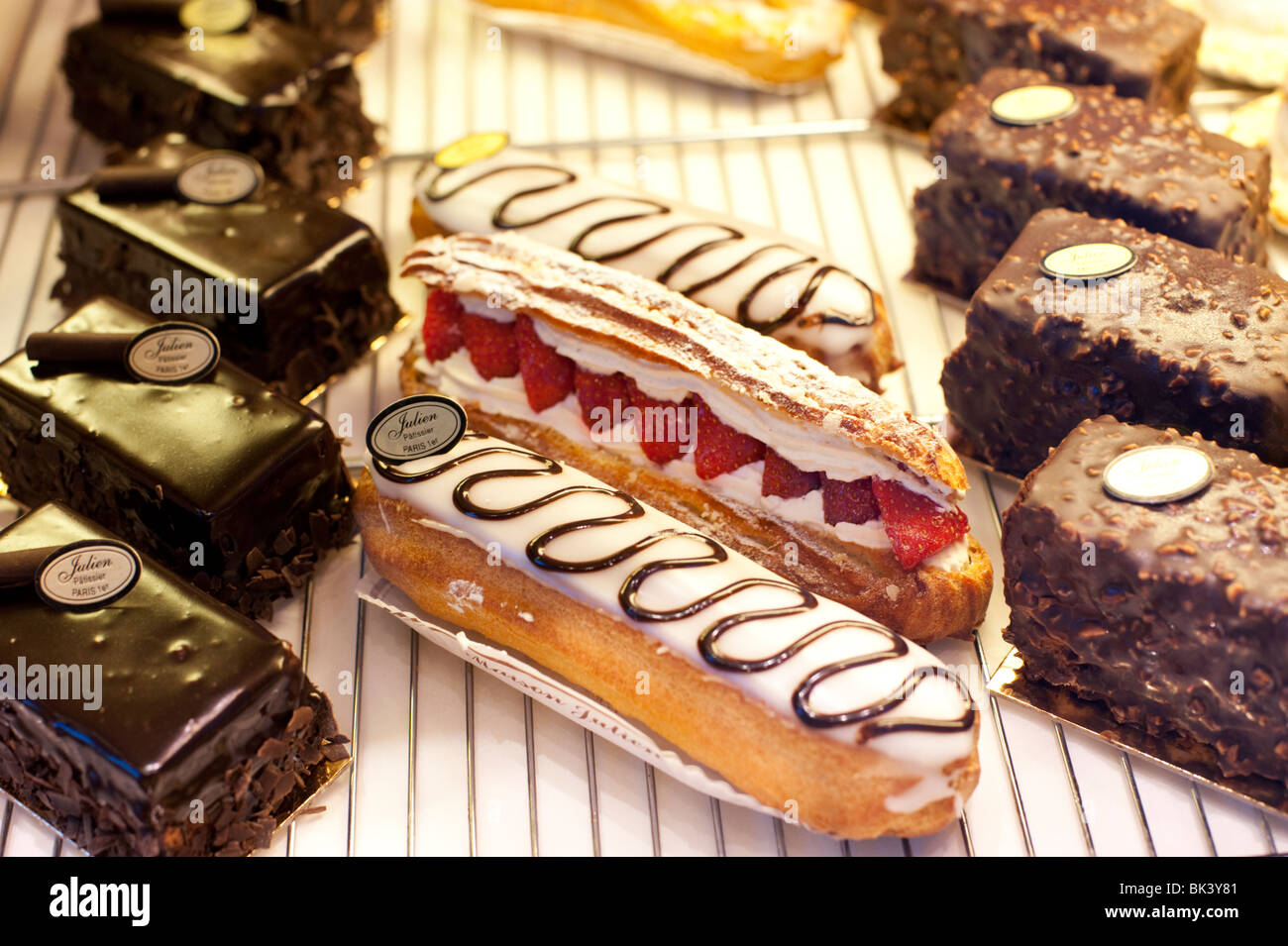 Eclairs with strawberries and chocolate pastries at a patissire in Paris, France Stock Photo