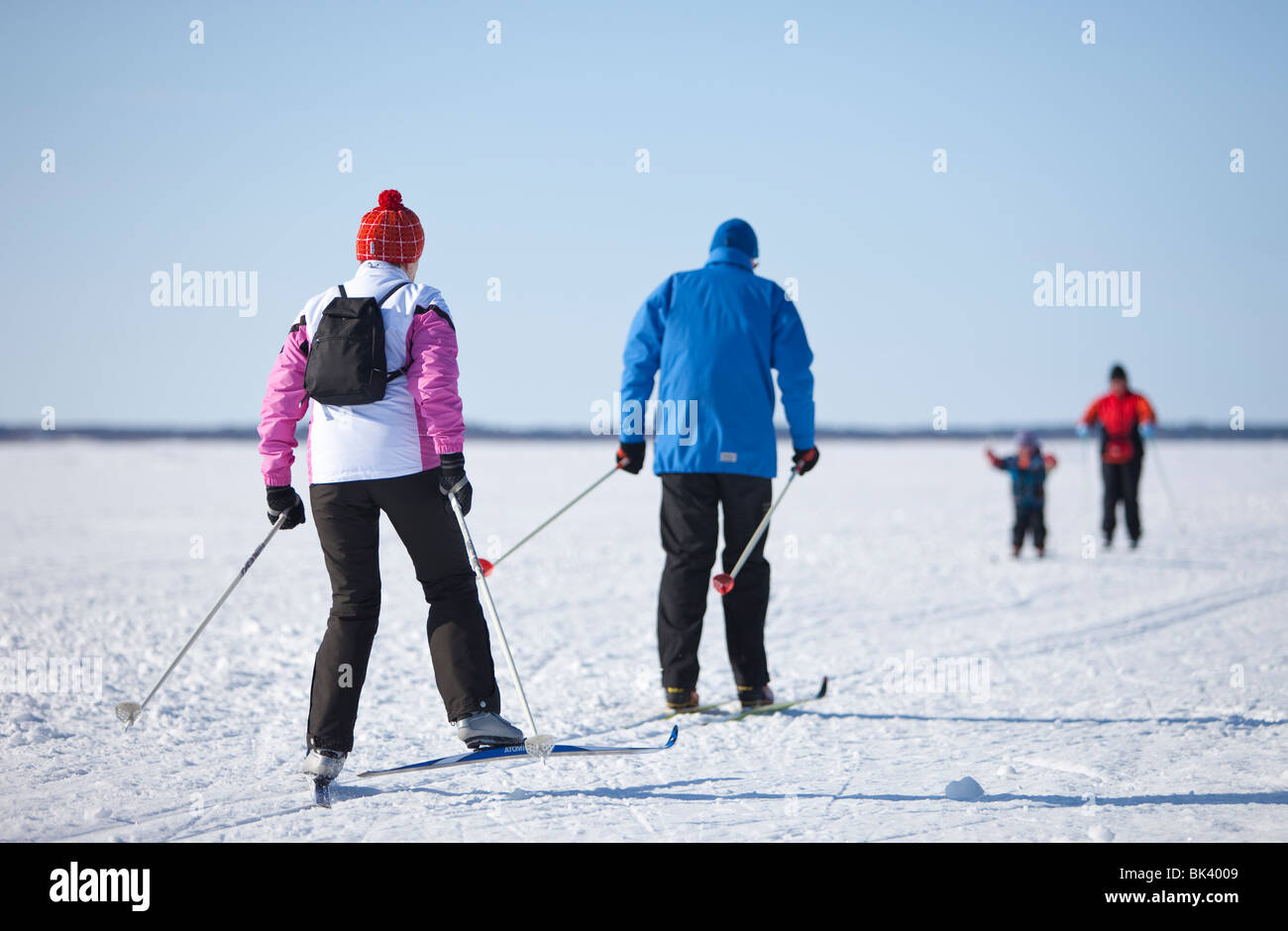 A couple cross-country skiing on a ski track made to sea ice , Finland Stock Photo