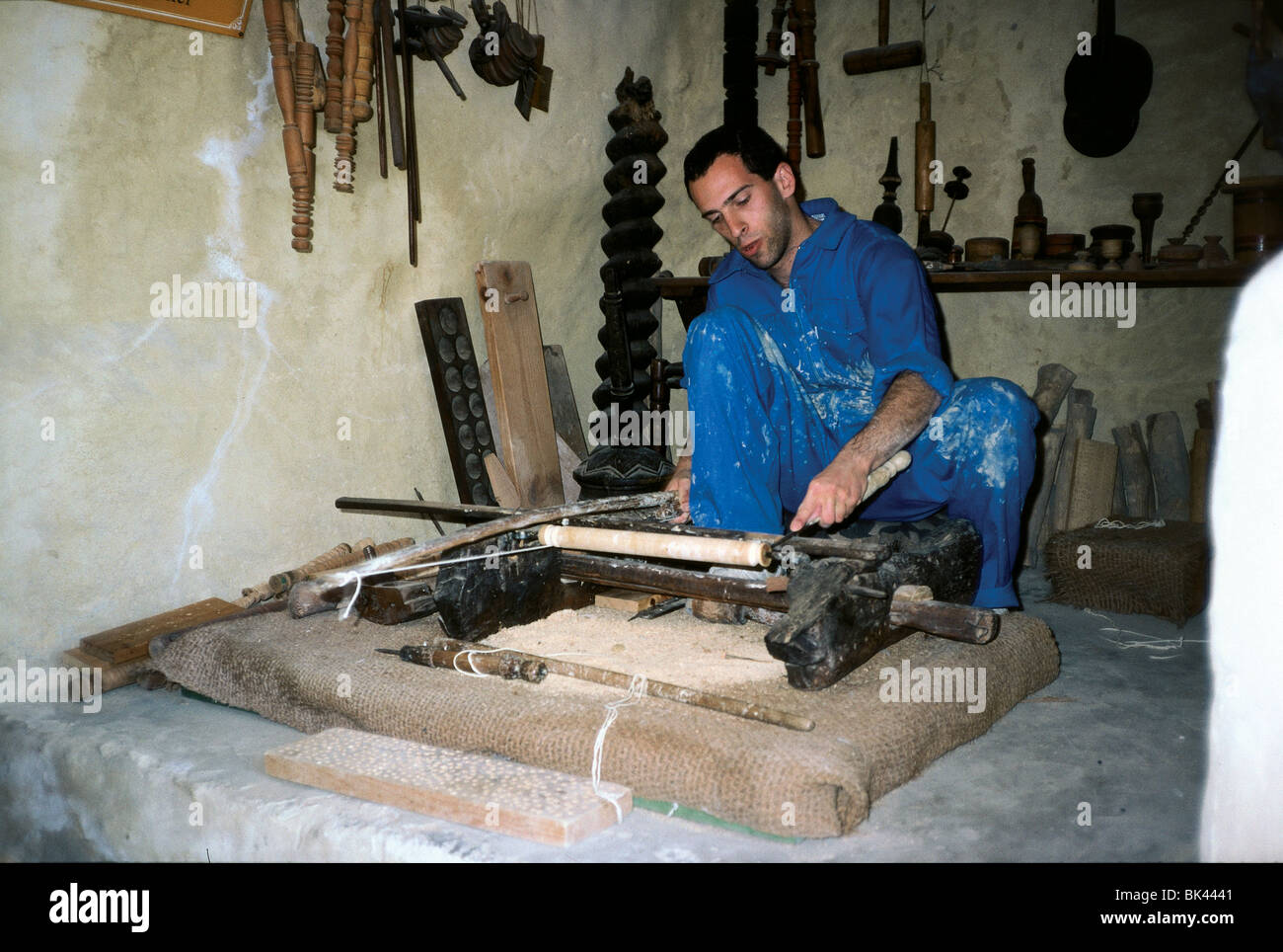 Carpenter demonstrating a hand-powered lathe in the Eretz Israel Museum, Tel Aviv, Israel Stock Photo