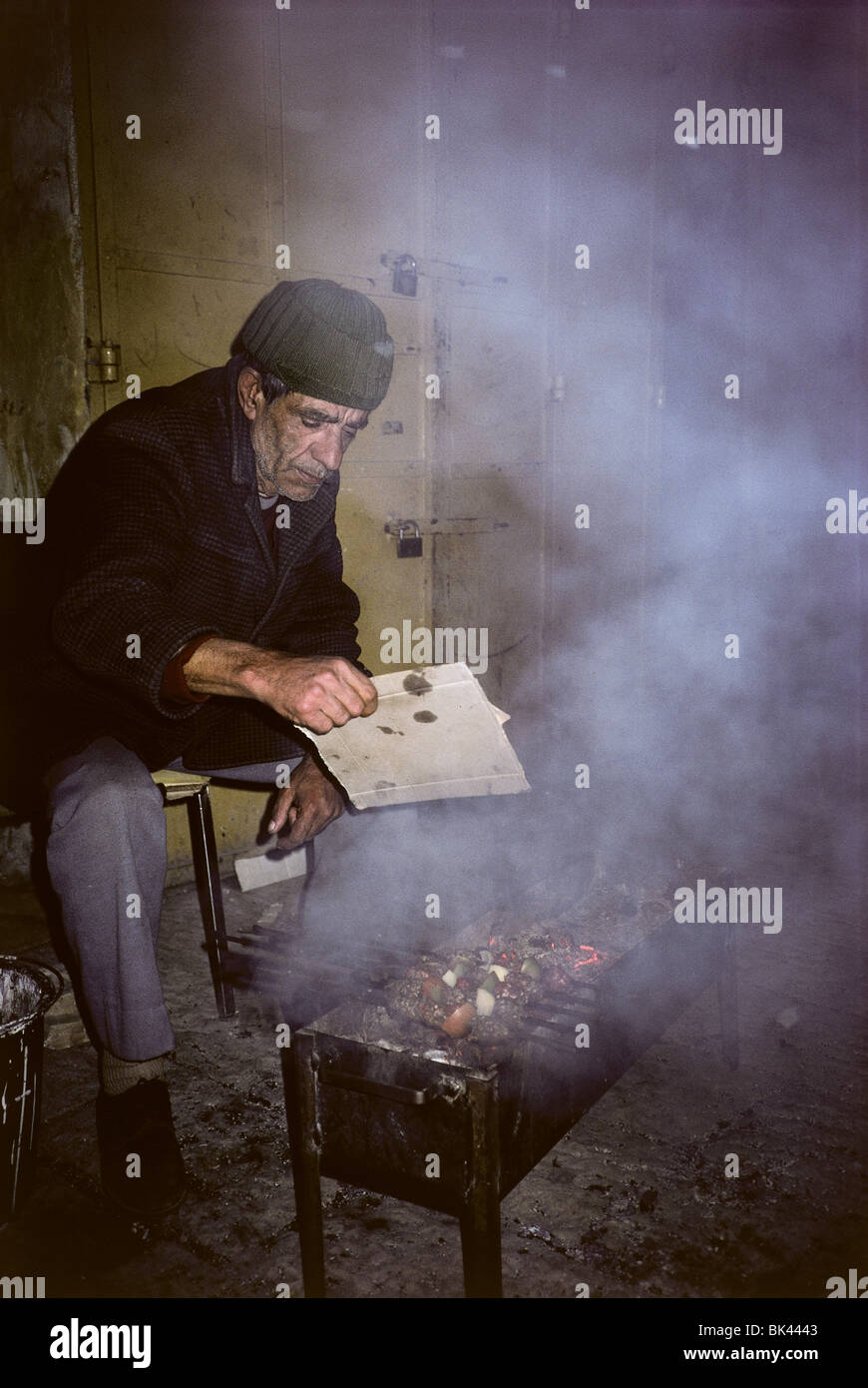 Man cooking kabobs over a charcoal grill, Israel Stock Photo Alamy