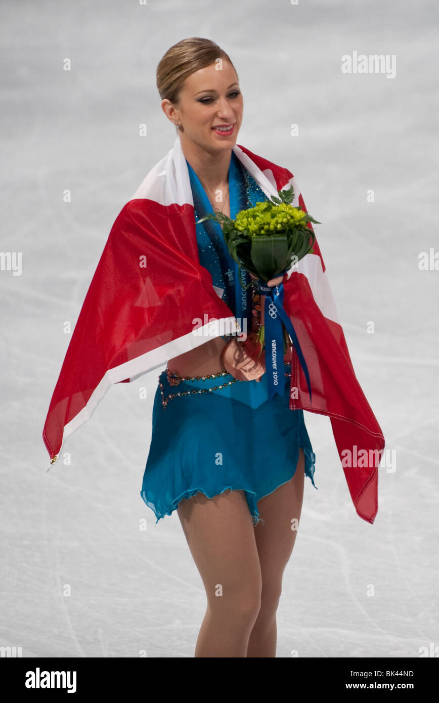 Joannie Rochette (CAN) wrapped in her country's flags after receiving their medals for Figure Skating Ladies Stock Photo
